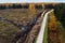 Aerial view of clear-cut area next to small road. Estonian nature, Northern Europe.