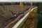 Aerial view of clear-cut area next to small road. Estonian nature, Northern Europe.