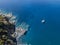 Aerial view of a cliff overlooking the sea and a moored catamaran, boat. Corsica. Coastline. France