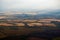 Aerial view of clouds, fields and a village landscape