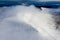 Aerial view of clouds moving over the summit of snow capped mountains