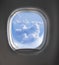 Aerial view of cloudy sky through airplaine window.