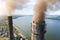 Aerial view of coal power plant high pipes with black smokestack polluting atmosphere. Electricity production with fossil fuel