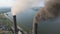 Aerial view of coal power plant high pipes with black smokestack polluting atmosphere. Electricity production with fossil fuel con