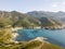 Aerial view of the coast of Corsica, winding roads and coves with crystalline sea. Gulf of Aliso. France