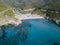 Aerial view of the coast of Corsica, winding roads and coves with crystalline sea. Gulf of Aliso. France