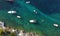 Aerial view of the coast of Mediterranean Sea. Beach resort vacation. Drone view of kayaks, sups, boats, swimming people in blue