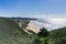 Aerial view of the coastal highway passing along a sandy beach in Montara, California