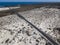 Aerial view of the coastal road that crosses the beaches and coves of MojÃ³n Blanco and Spiral Caleta. Lanzarote, Canary Islands,