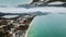 Aerial view of the coastal small town and the turquoise sea with a horizon mirror effect. Beautiful sea shore with a