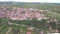 Aerial view of coastal tourist village on a hill, Athitos Halkidiki Greece, movement back and up by drone