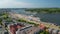 Aerial view of coastal urban district with various colourful houses and large parking lot with Ferris wheel attraction