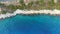 Aerial view of coastline rocky cliff with green trees in Mediterranean sea