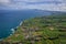 Aerial view of the coastline on Sao Miguel Island, with town buildings, green farmland and volcanic mountains, Azores, Portugal