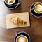 Aerial view of coffee cups and croissant on wooden table