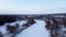 Aerial view on cold frozen wintery river in snow