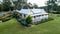 Aerial view of colonial sandstone cottage house with picket fence, garden, grass and eucalyptus gum trees