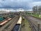 Aerial view of colorful freight trains on railway station. Wagons with goods on railroad. Cargo trains. Heavy industry. Industrial