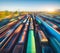 Aerial view of colorful freight trains at sunset. Cargo wagons