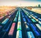 Aerial view of colorful freight trains at sunset. Cargo wagons