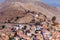 Aerial view of colorful traditional multi-colored houses on a mountainside on Symi island