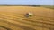 Aerial view of combine filling truck wheat