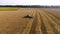 Aerial view of combine filling truck wheat