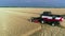 Aerial view of combine harvester. Harvest of wheat field. Industrial footage on agricultural theme.