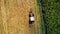 Aerial view of combine harvester, tractor on hay field. Agriculture and harvesting. Wheat production .