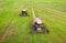 Aerial view of combine harvesters on agricultural field. Harvesting time. Harvester on green agriculture field