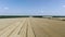 Aerial view Combine Harvesters gathers the wheat