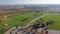 Aerial view community recreational center with grassy lawn soccer fields, colorful autumn leaves and plateau farm prairie leading