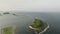 Aerial view of concrete sea wall on small sandbar island off coast