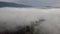 Aerial view of coniferous forest through clouds in a mountainous region of Slovakia, Tatra Mountains