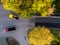 Aerial view of the construction of a new road as asphalt pavers, rollers, machinery, and workers come together to build