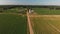 Aerial view of corn fields and a dirt road. Summer country landscape.