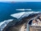 Aerial view Corralejo town, harbour, black rocks, blue water, Lobos and Lanzarote islands, Fuerteventura, Canary islands, Spain
