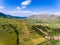 Aerial view of Costesti Village in Apuseni Romania withh Rimetea Piatra Secuiului Mountain in the back