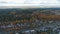 Aerial view cottage town near wood against morning sky