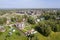 Aerial view of a cottage village on the background of a condominium under construction in Siberia