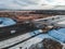 Aerial view of country road and bridge, road  traffic, snow-covered forests and fields, winter. Russia, St. Petersburg