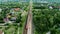 Aerial View of Country Train Station in Summer. Houses, cars, train on railroad