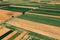 Aerial view of countryside farming field patchwork from drone pov