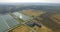 Aerial view of countryside, forest, fields, greenhouse and research site. 4K