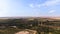 Aerial view of the countryside: High voltage line, gas station, quarry, farm fields