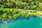 Aerial view of countryside road passing through the green forrest