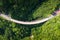 Aerial view of countryside road passing through the tropical rainforest and mountain in SouthEast Asia