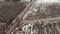 Aerial view with countryside road and snow covered plowed agriculture fields