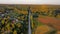 Aerial view of countryside road sunset. Golden sunset of community gardens, farm and road sunset.