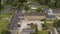 Aerial view of countryside stone ancient house located near the green forest in the contrast with modern swimming pool